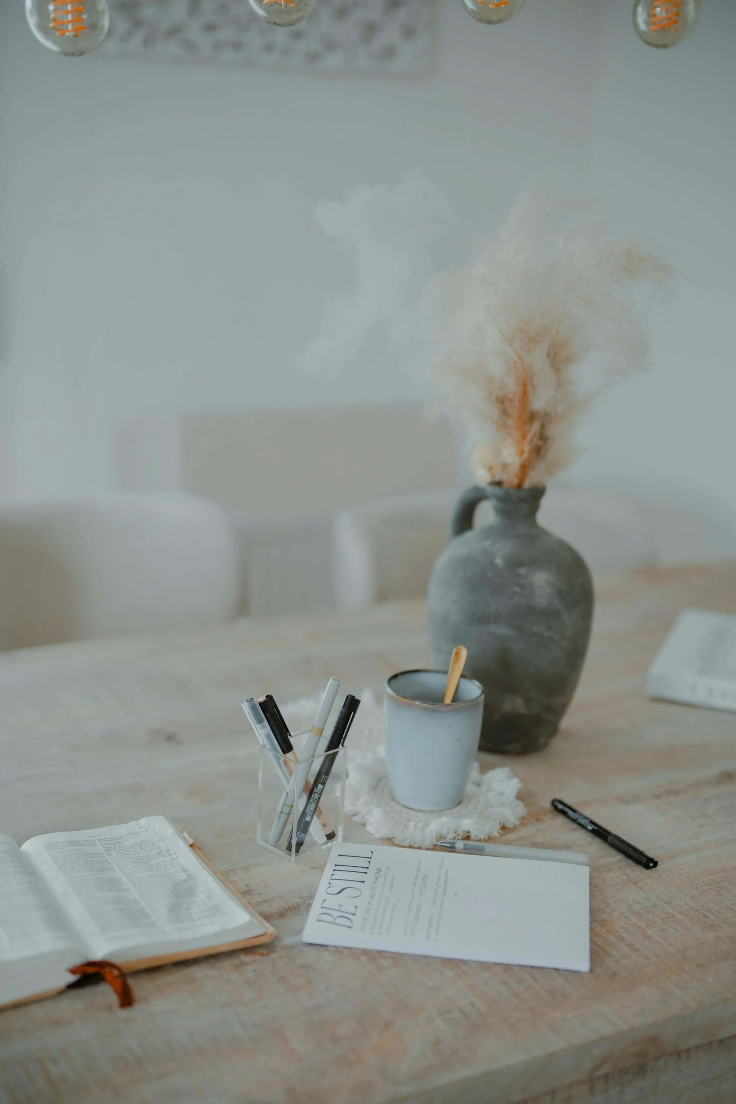 A table on the bible open with a bible verse written on a piece of paper for a blog post on bible verses to carry everyday