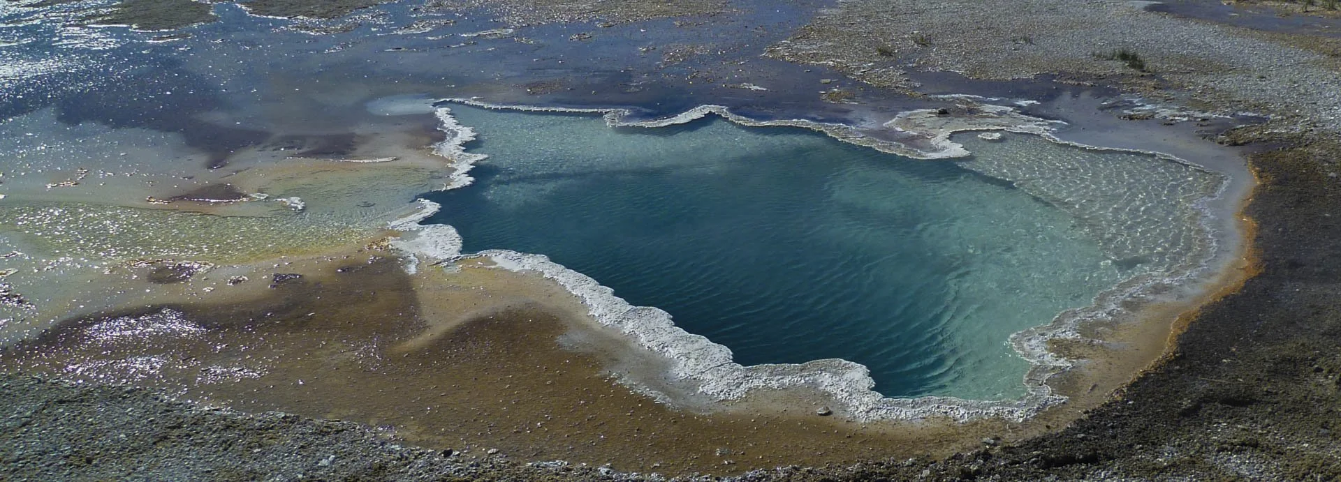 Celestine Pool surrounded by colourful mineral deposits in Yellowstone National Park, USA.