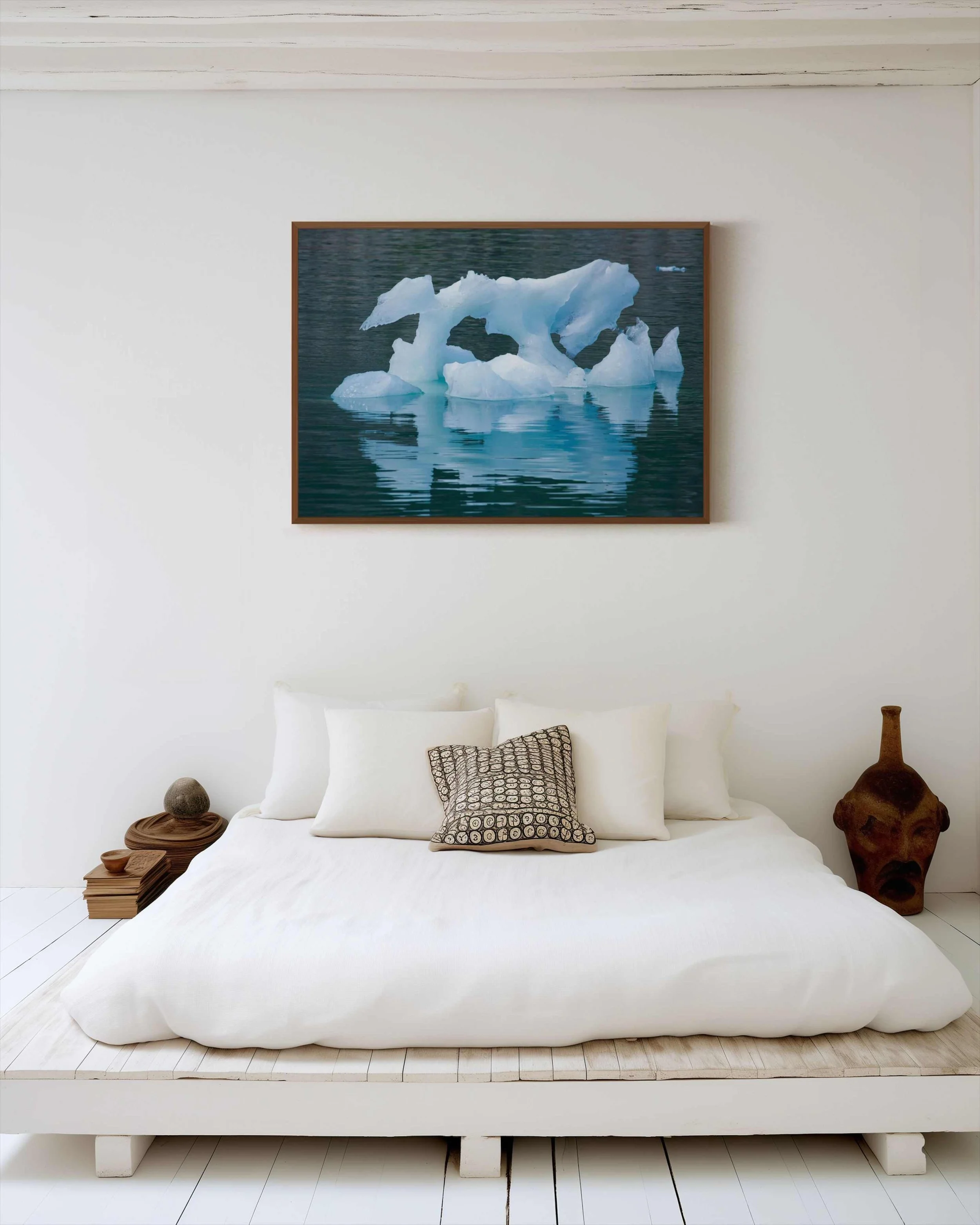 Ice Sculpture Fine Art photograph depicting a sculptural blue iceberg floating on calm water, Alaska, displayed in a bedroom, mounted on Dibond in an Alder Brown wood frame.