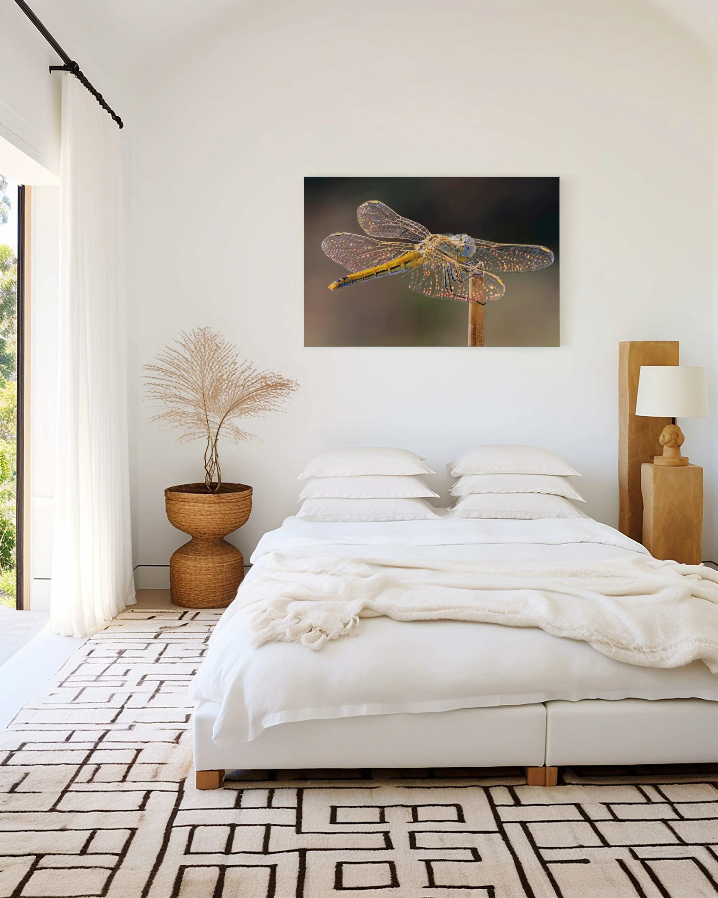 Stained Glass dragonfly Fine Art print displayed above a white bed in a contemporary bedroom with natural textures.