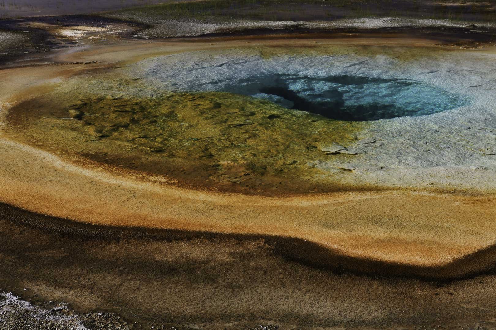 Colorful mineral terraces and turquoise hot spring at Morning Glory Pool in Yellowstone National Park, USA.