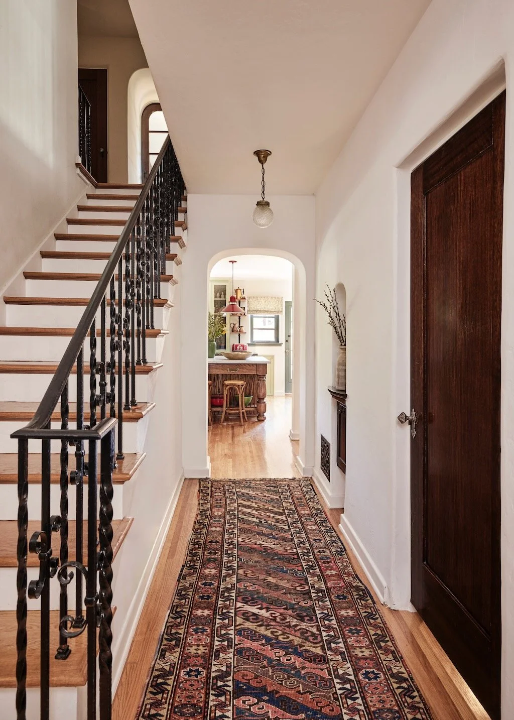 Spanish Colonial Revival arched interior doorway in Los Angeles with original plaster walls and wrought iron light fixture Caption: The arch is the most valuable thing in most of these houses. It's also the first thing people square off.