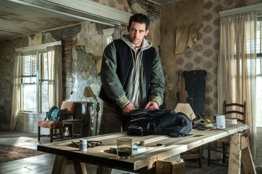 Daniel Kellmer (Josh O'Connor) unzips backpack full of alien conspiracy government secrets from the kitchen of a safe house in DISCLOSURE DAY.