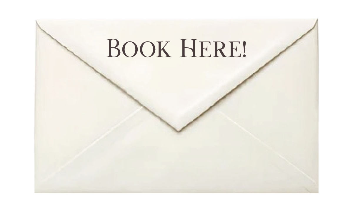 A white envelope with a note inside that reads 'BOOK HERE!' in large black text.