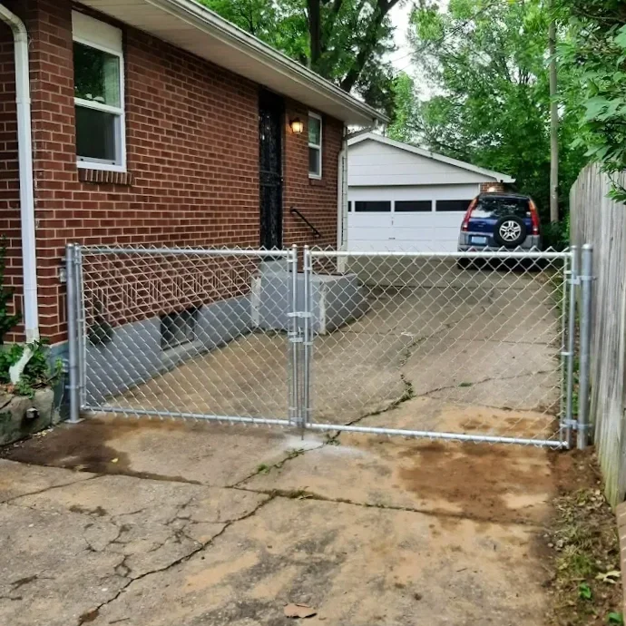 4 ft tall chain link double drive gate, galvanized attached to house with drop rod and fork latch