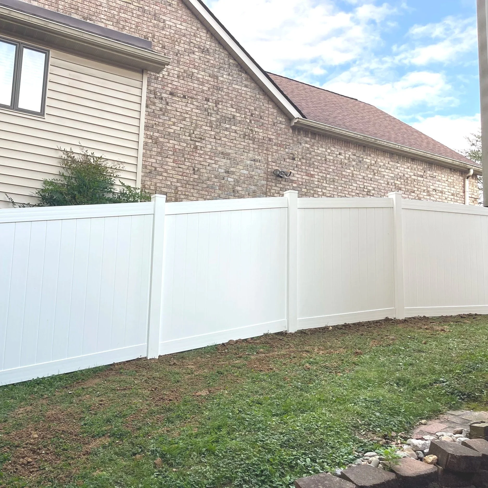 6' white vinyl privacy on a slope, catalyst fence, pvc, post caps, rails, pickets