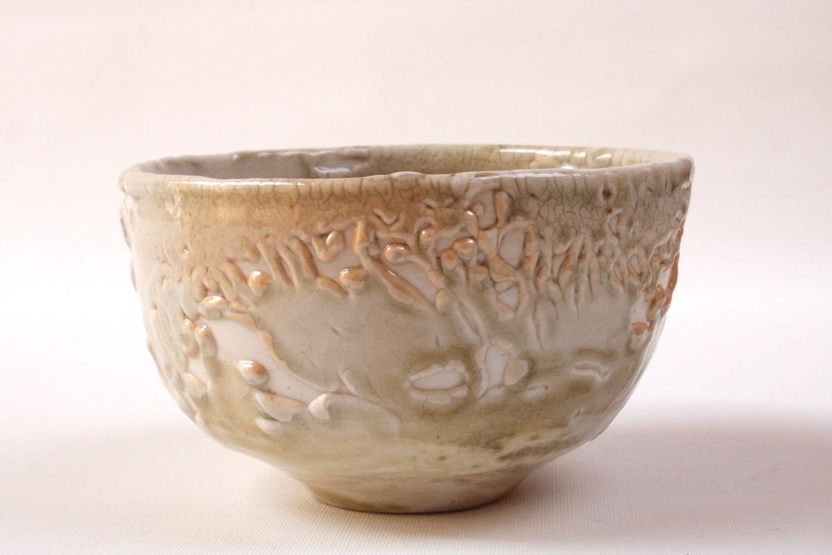 Eine handmade Keramikschale mit einer texturierten Oberfläche und einer weißen bis beige Farbgebung.