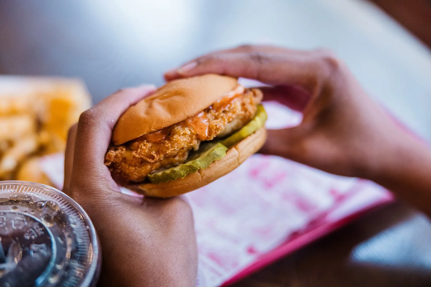 Man eating Fried Chicken Sandwich with Pickles