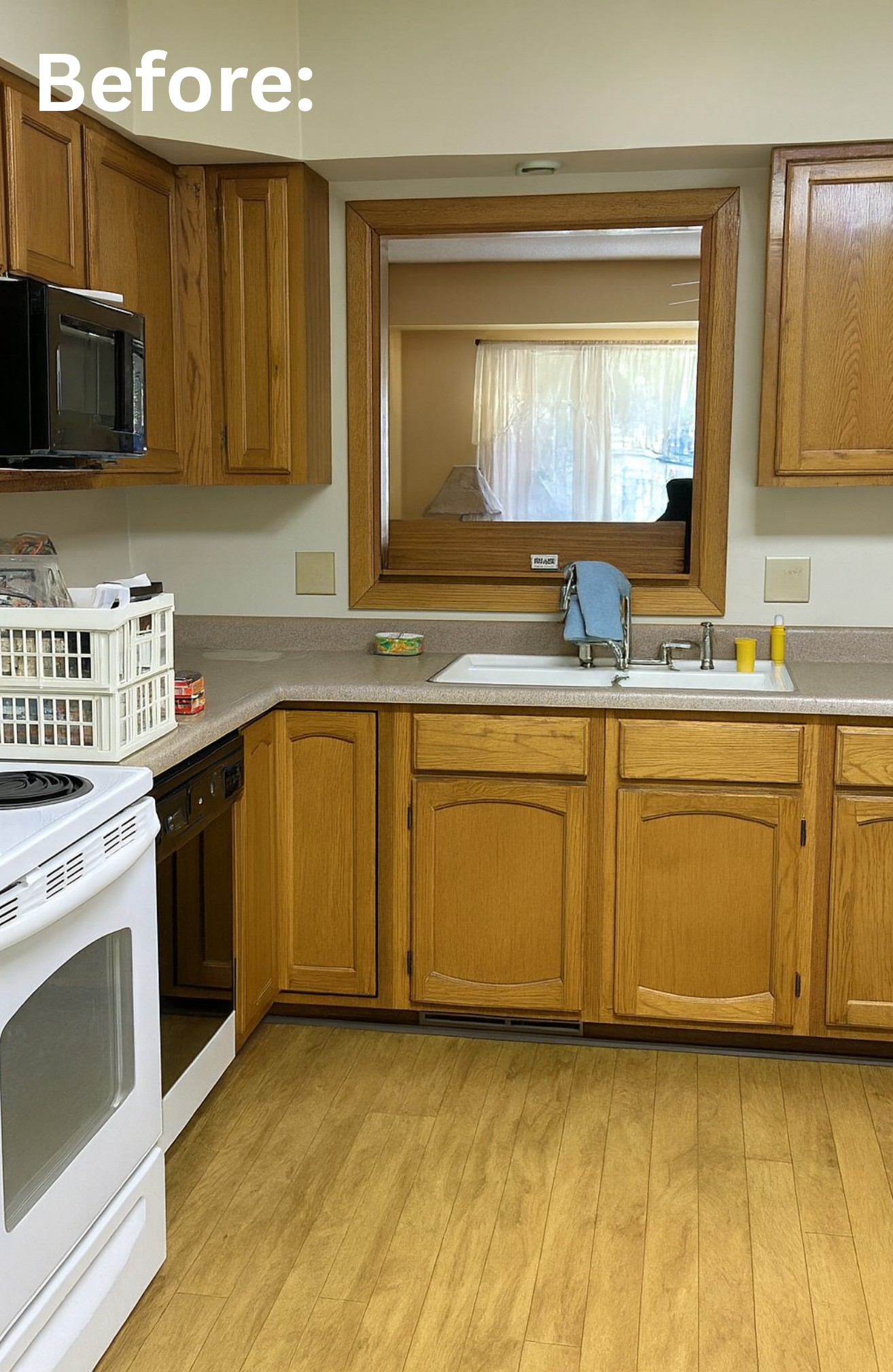 Kitchen with wooden cabinets, a white stove, a countertop, and a sink. Showcasing the before photo of this kitchen remodel and cabinet refinishing.
