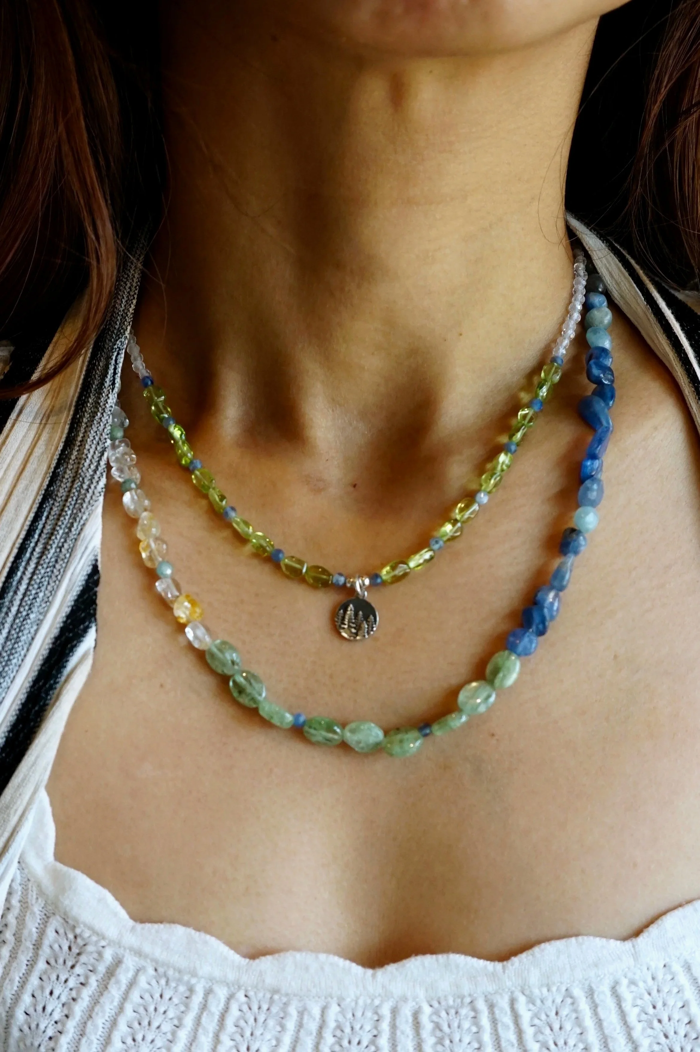 Jeweliana Studio Lake Tahoe chunky kyanite and clear topaz necklace layered with peridot nugget and silver pine tree pendent necklace
