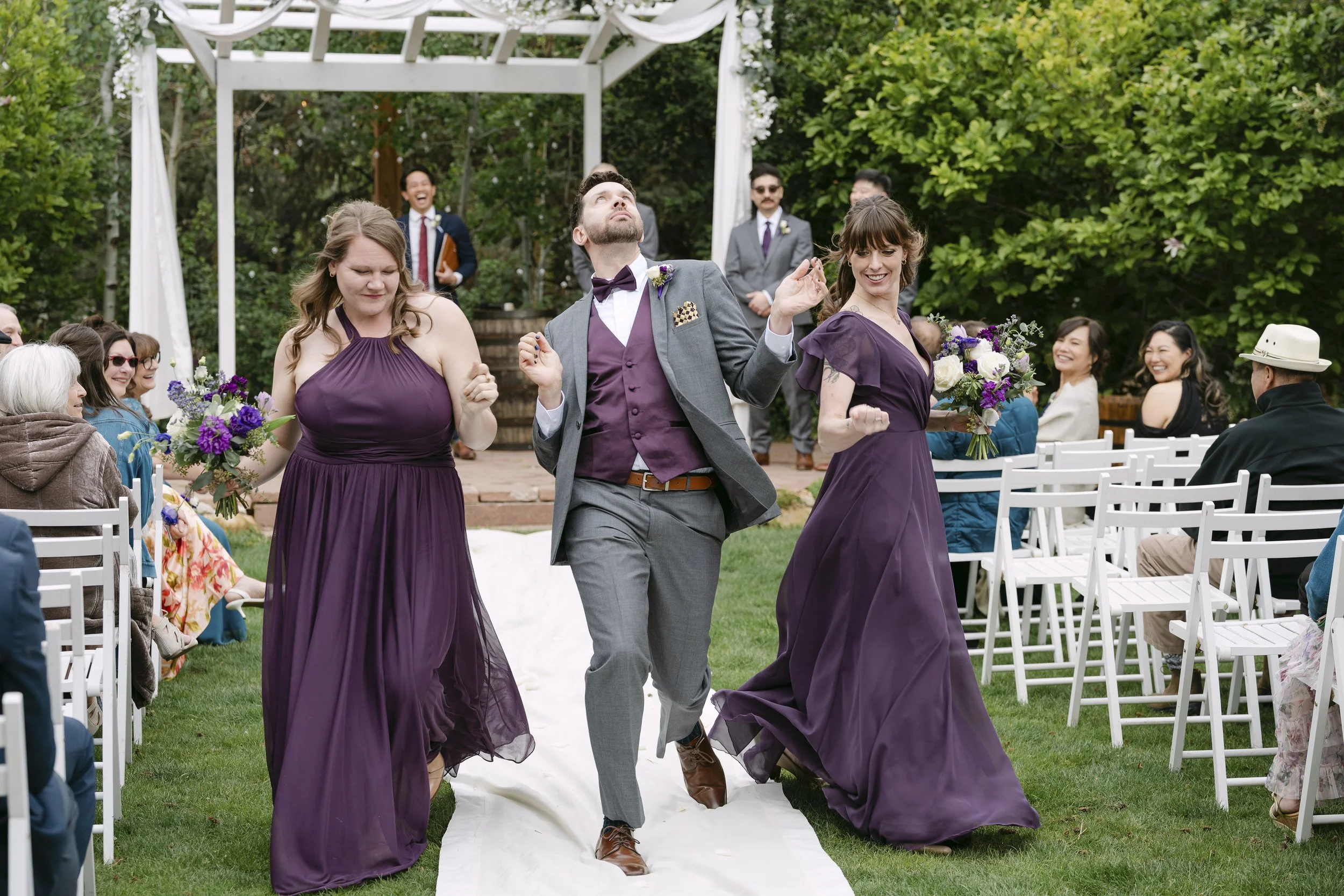 Catherine's bridal party dancing down the aisle during their wedding recessional at a local Denver wedding venue