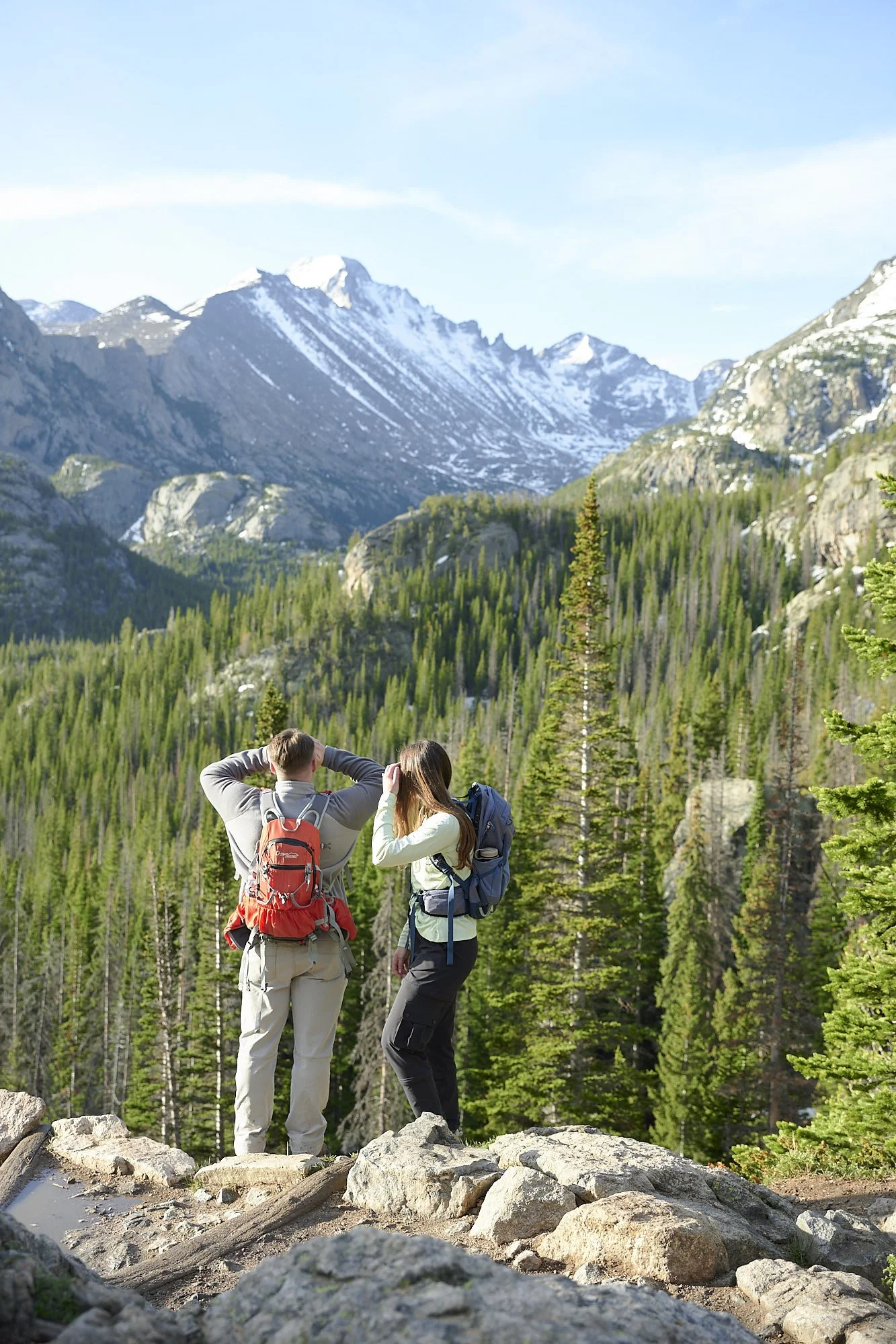 A couple stares off into the distance at an overlook along the trail.