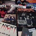 A collection of vintage band and movie posters displayed on a surface.