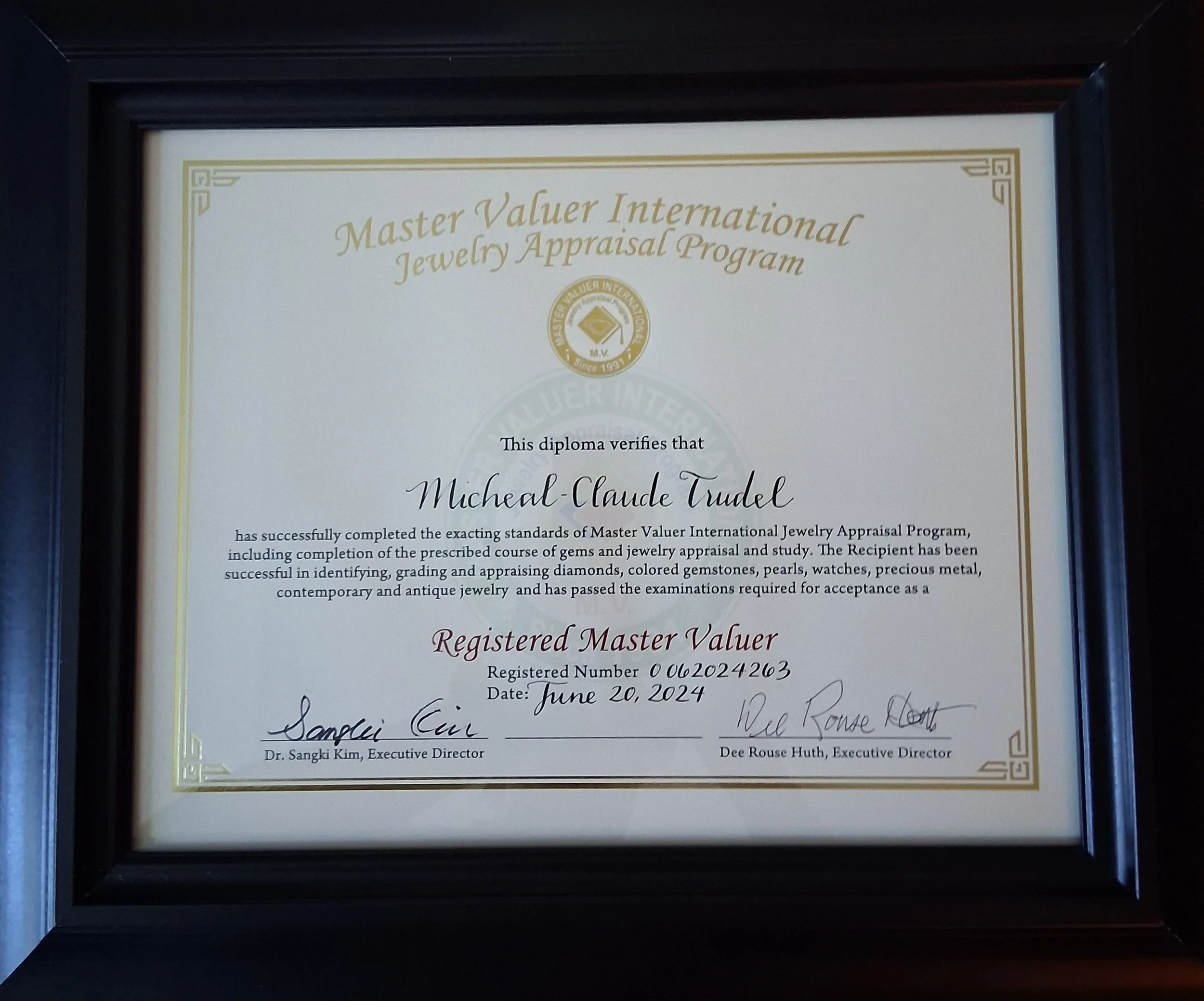 Certificate of completion from Master Valuer International Jewelry Appraisal Program awarded to Michael-Claude Trudel, signed by two executives, dated June 20, 2024.