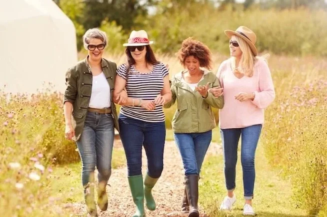 Group of adults living active lives after ostomy surgery with ongoing support and care from ostomy nurses