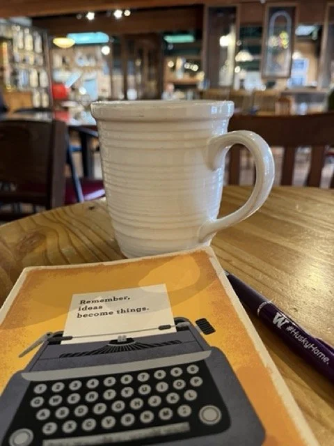 Notebook and coffee cup on a table in a coffee shop