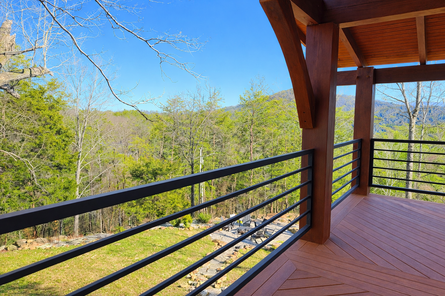 Modern black steel railing installed on a mountain cabin deck with scenic Smoky Mountain views.