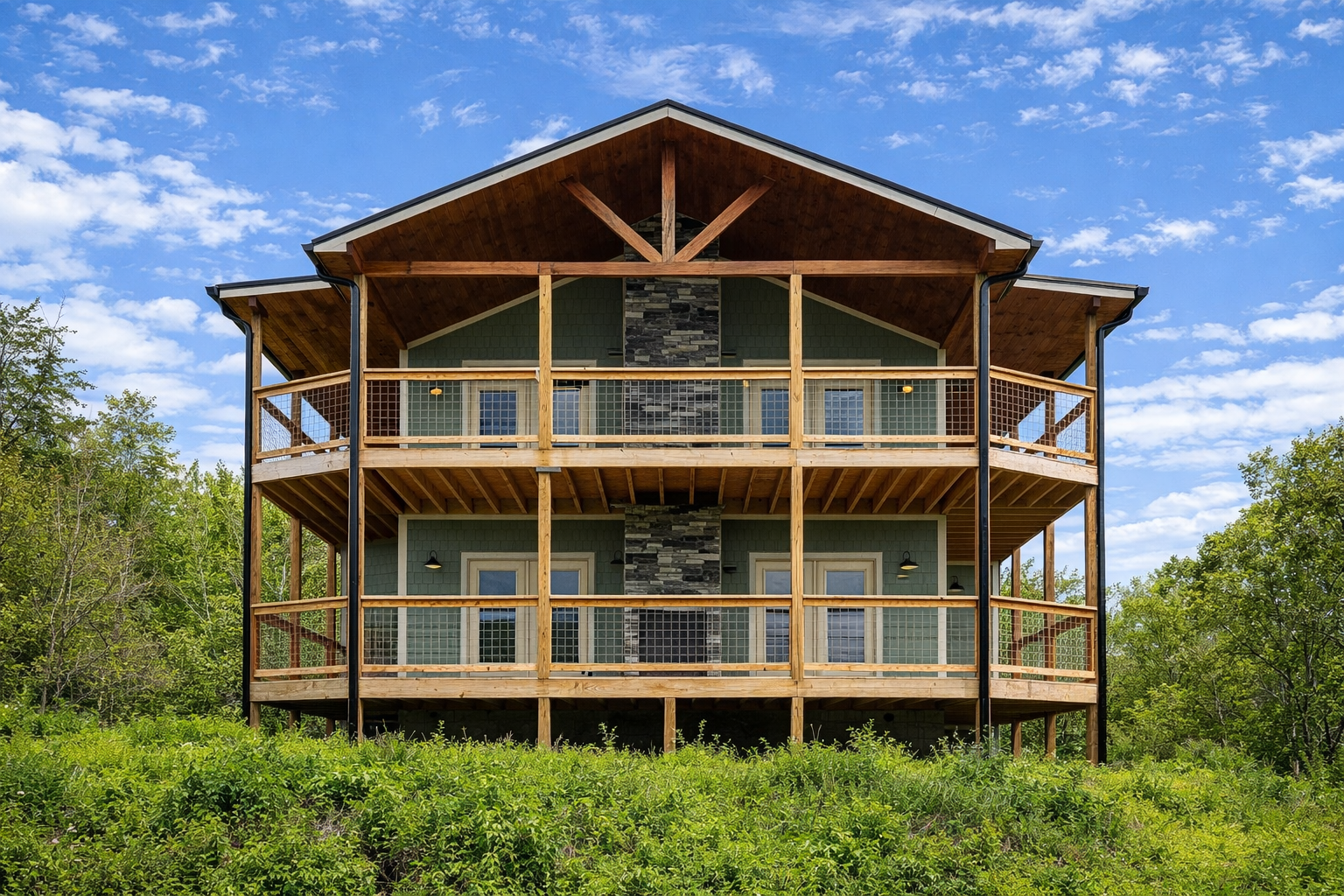 Modern hog wire railing system installed on elevated mountain cabin balcony with open views.