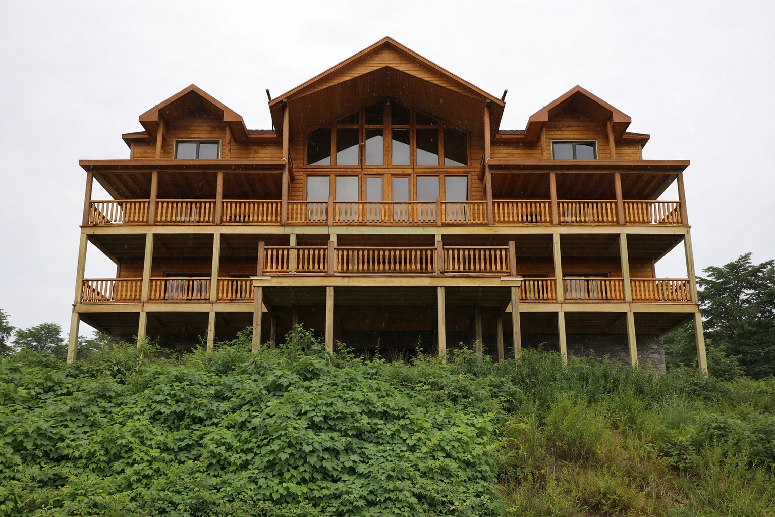 Log style wooden railing on a Smoky Mountain cabin porch with natural wood spindles and wraparound deck.