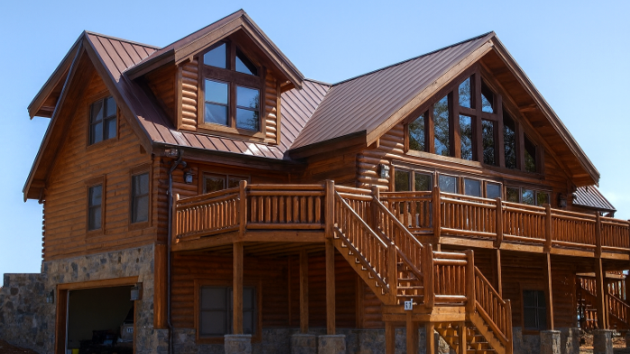 Premium timber railing system installed on an outdoor cabin deck with scenic mountain backdrop.
