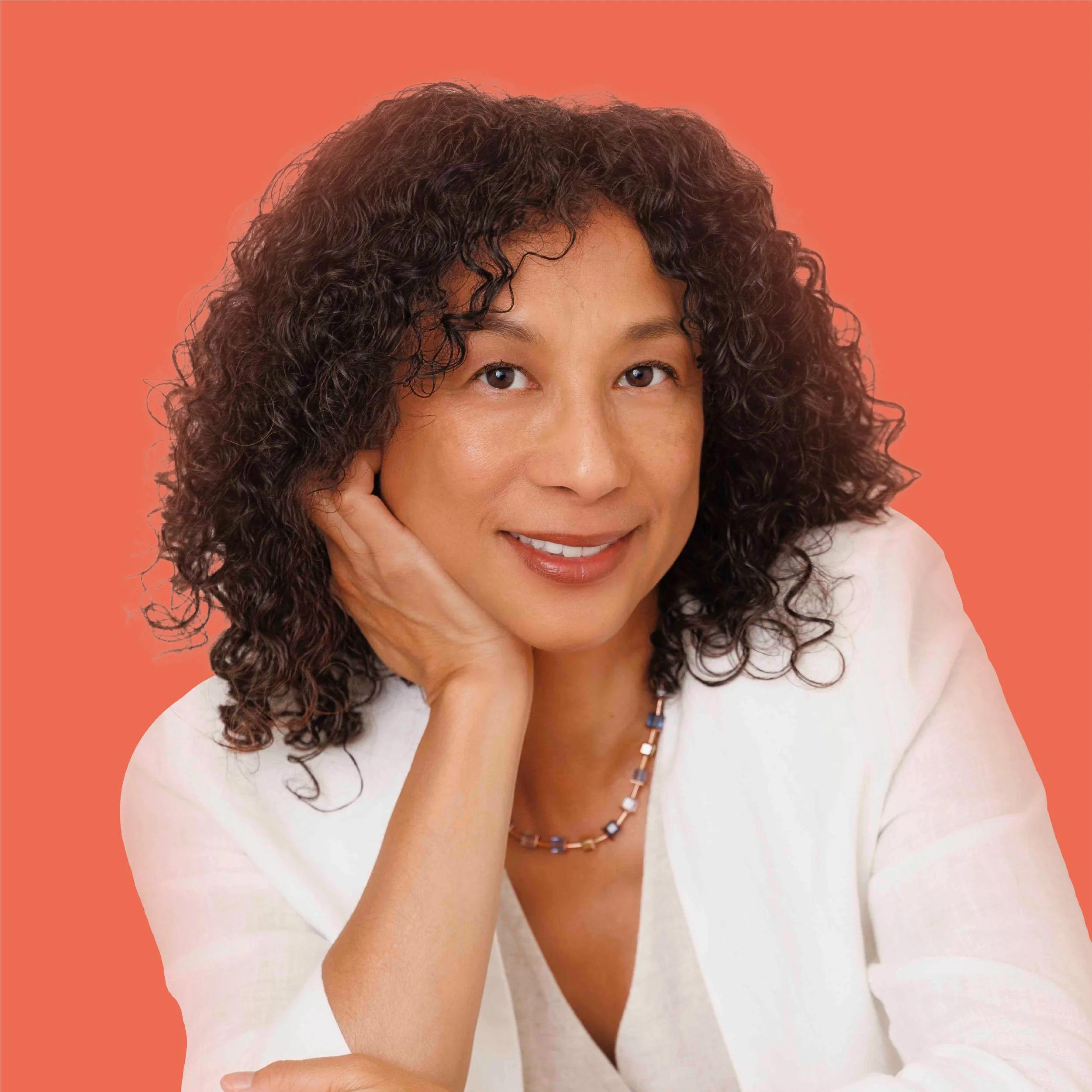 Yumi Wilson, journalist and coach, photographed in natural light with a warm, approachable expression.