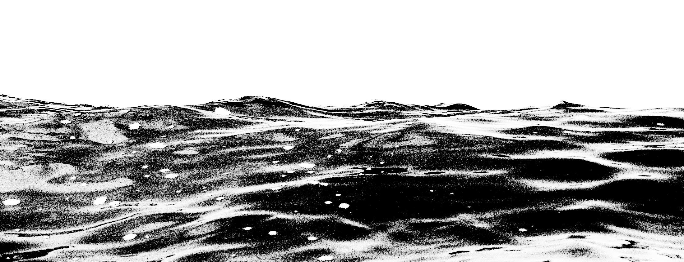 A black and white photo of ocean waves with a clear sky above.