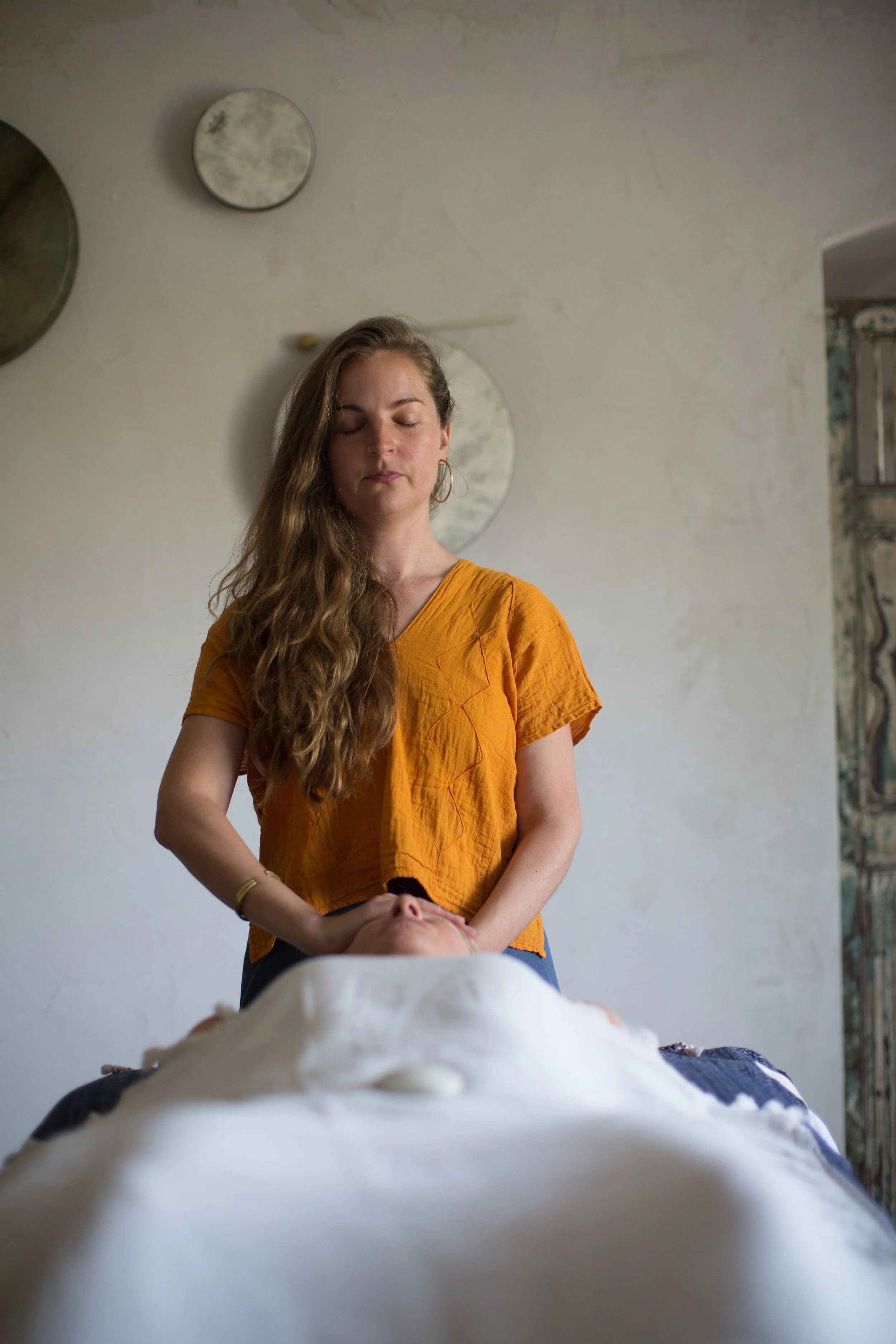 Anna Kelley, Reiki healer, with her hands placed gently on an individual.