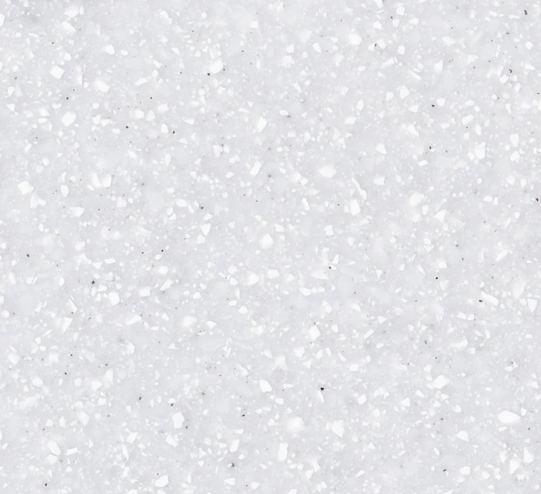 Close-up of white speckled Staron Aspen Snow surface.