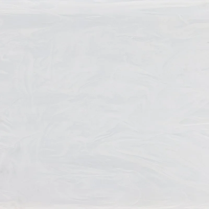 A soft off-white benchtop material with white and grey veins. Staron Supreme Arctic White