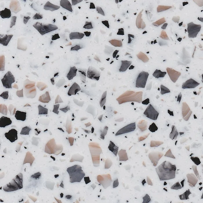 A beautiful white benchtop material with black, grey, white and blush terrazzo specks.Staron Terrazzo Venezia Solid Surface