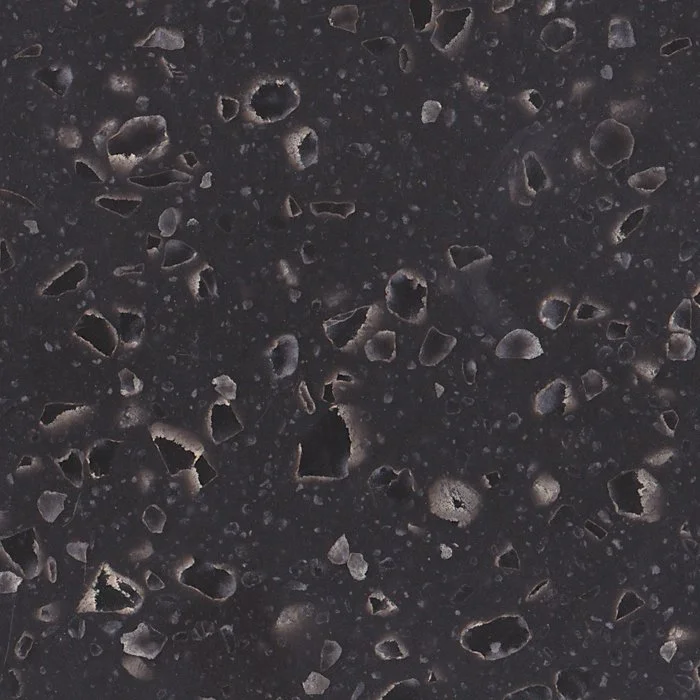 Close-up of a dark, textured surface with imbedded flecks. Staron Mosaic Nimbus