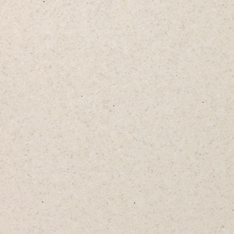 Close-up of a beige, speckled Staron Aspen Stucco surface.