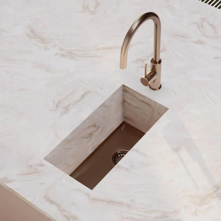 Close-up of a modern kitchen sink with Copper Corian AXIX 190 sink
