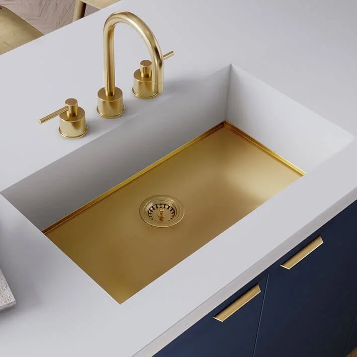 White kitchen sink with a Brass Corian AXIX 700 sink