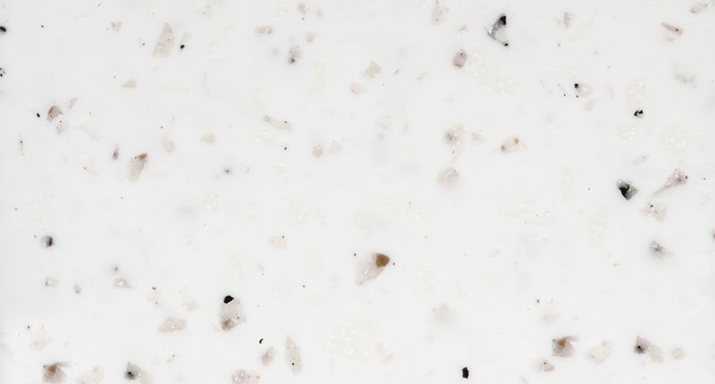 A white benchtop material with soft brown, off-white, grey and beige flecks imbedded. Meganite Cotton Boulder