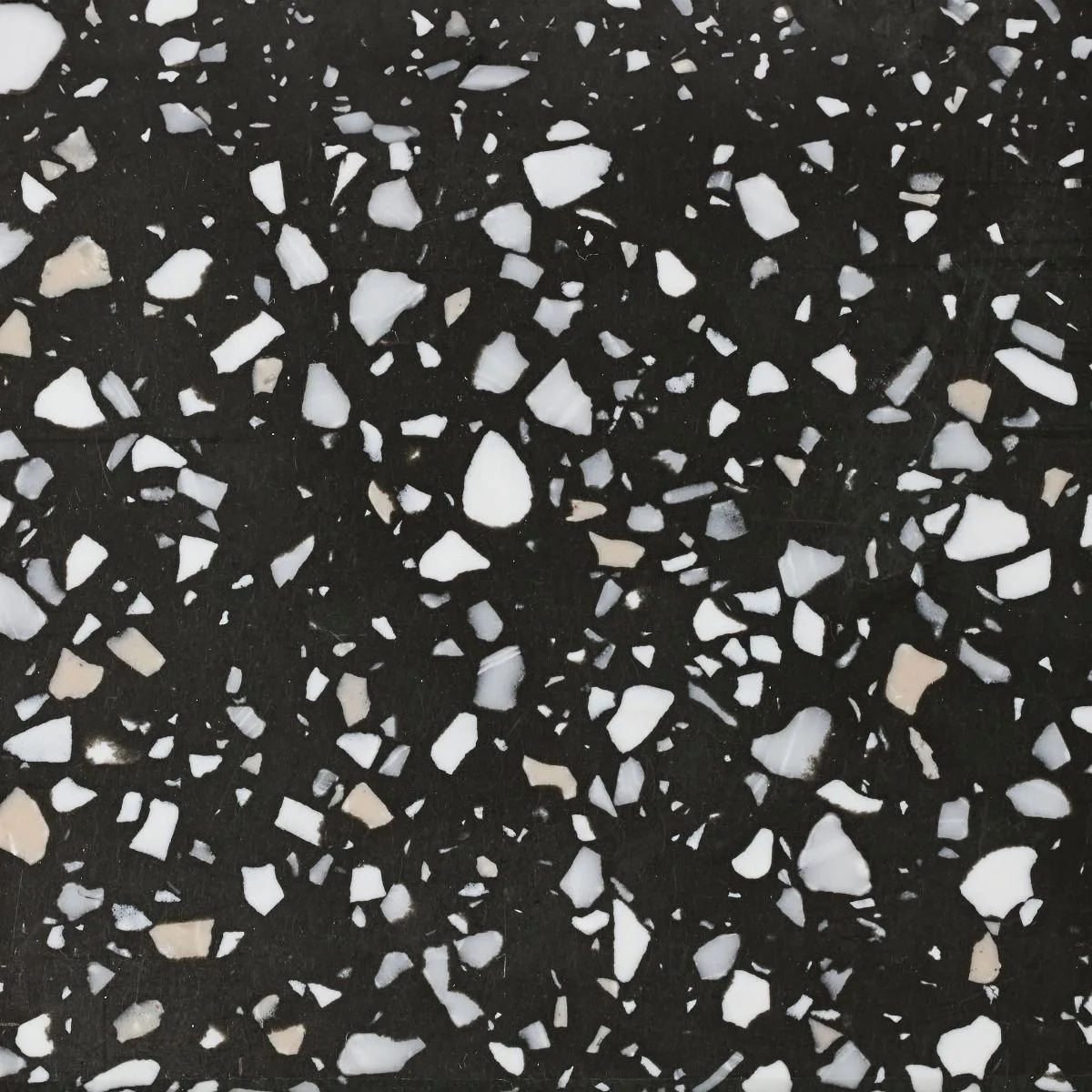 A funky black based terrazzo benchtop material with white, grey, and beige specks. Meganite Urban Terrazzo.