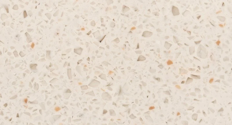 A warm beige based benchtop material with soft brown and orange terrazzo like flecks. Meganite rice pudding.