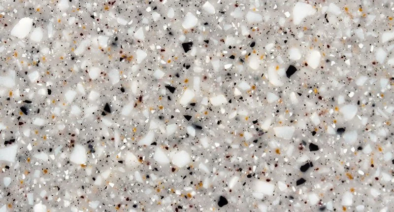A grey based benchtop material packed with black, white and brown flecks. Meganite Platinum Granite.