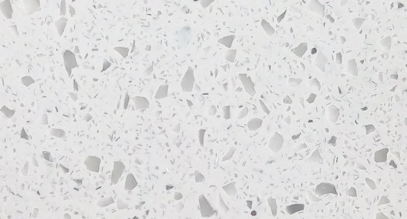 A light grey, white based benchtop material with grey terrazzo like flecks. Meganite Urban Habitat