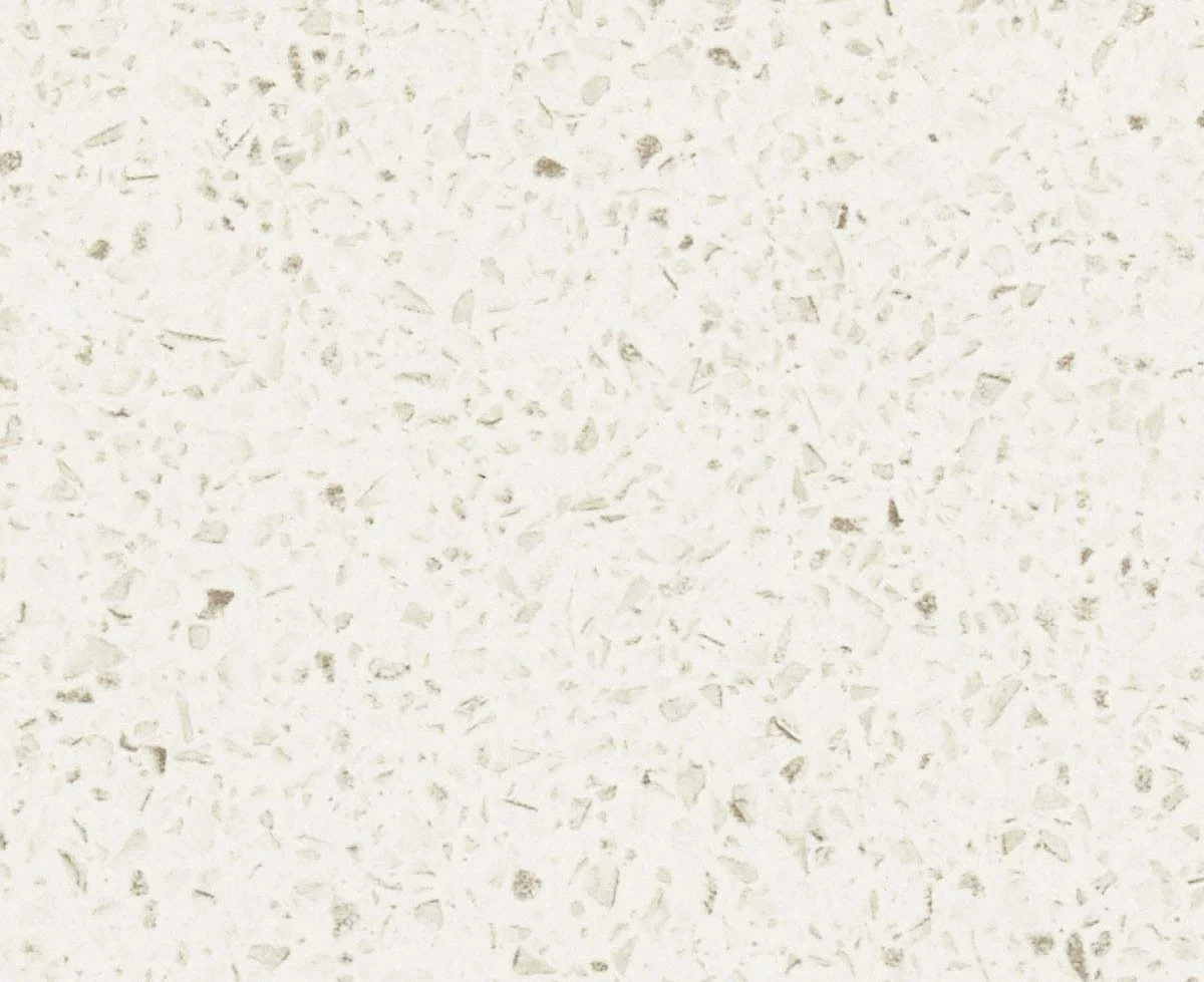 Close-up of white speckled terrazzo surface with small gray and beige chip fragments.