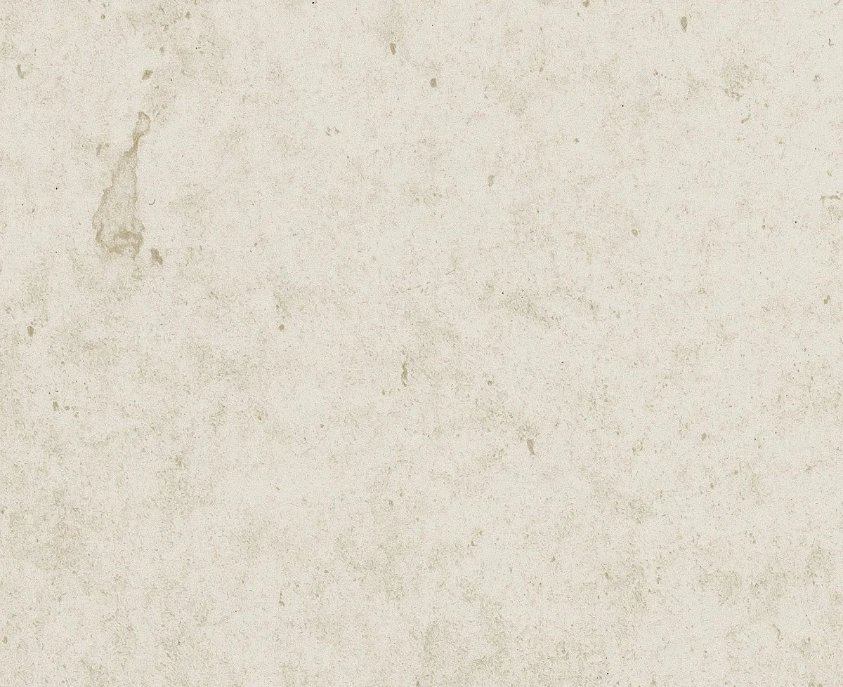 A plain, textured beige wall with some discoloration and small marks.