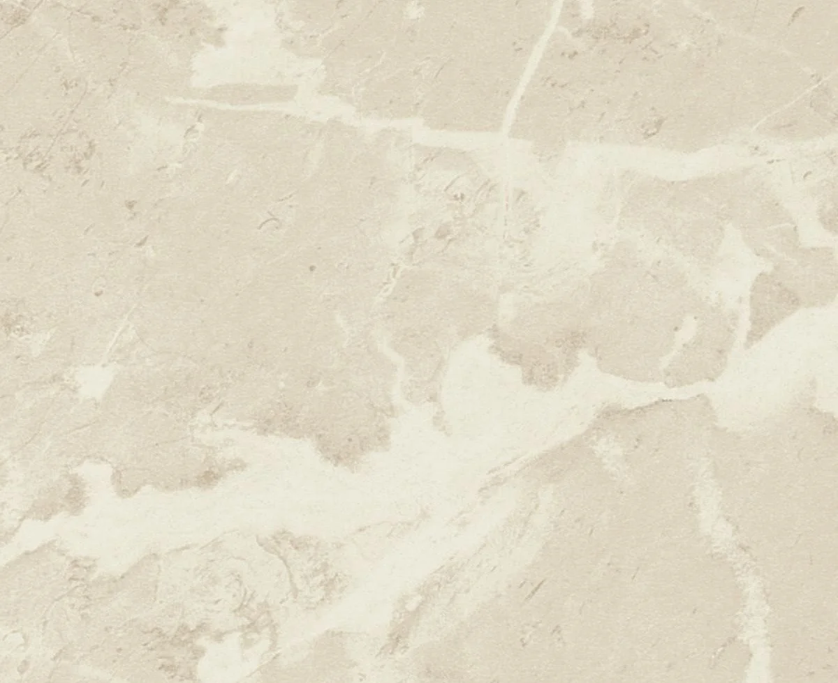 Close-up photo of a light-colored, textured stone or marble surface with natural veining.