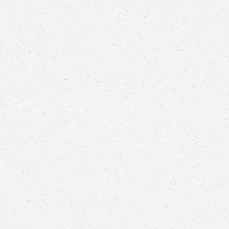 Close-up of a plain white surface with tiny dark speckles.