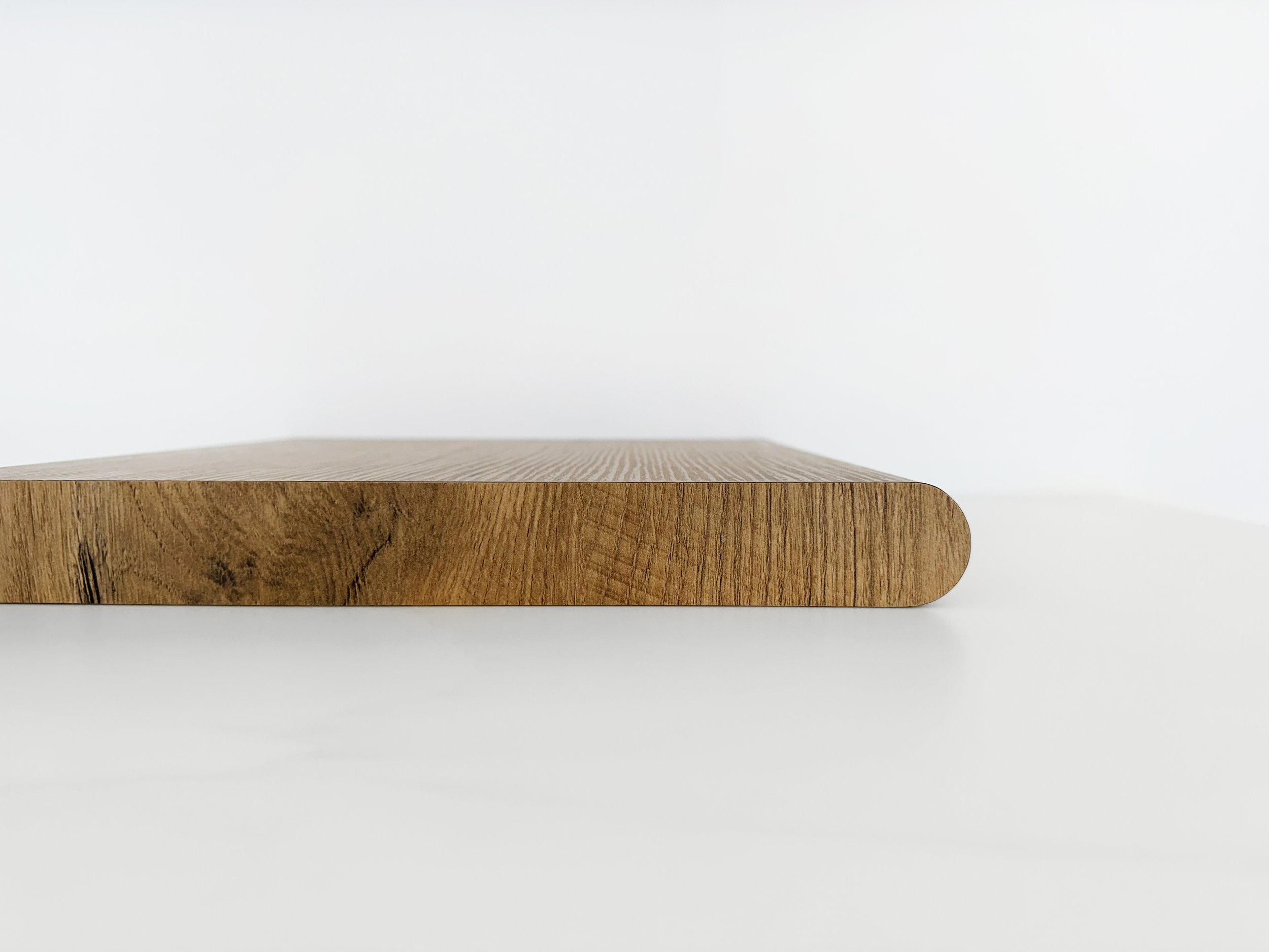 A timber laminate sample showcasing a bullnose edge profile