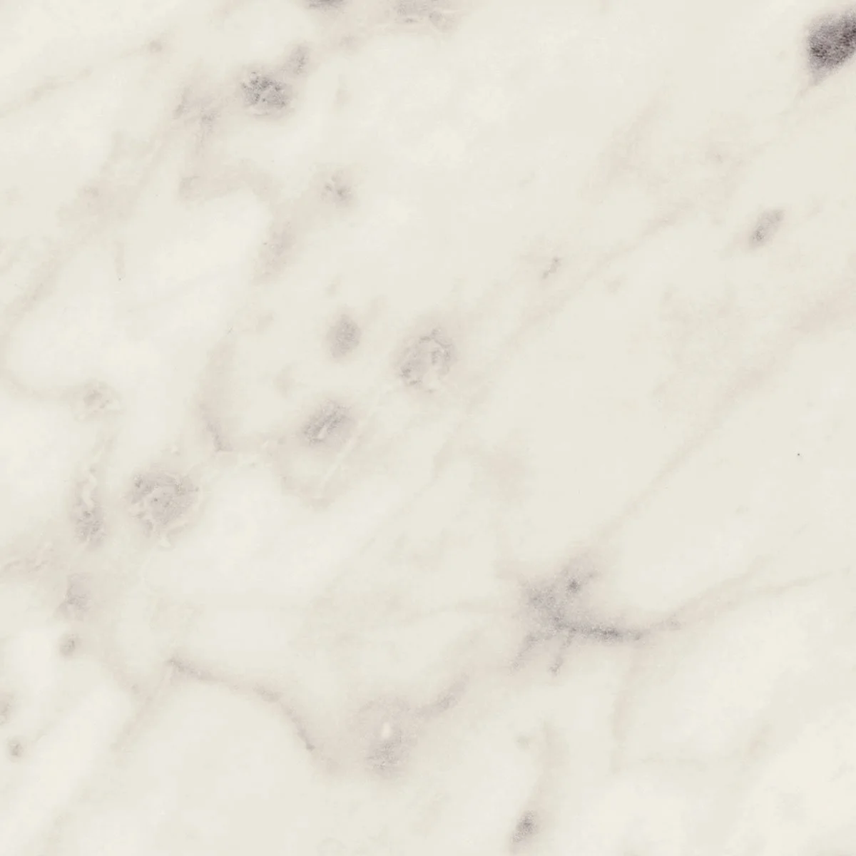 Close-up view of a light-colored marble surface with gray and black veining.