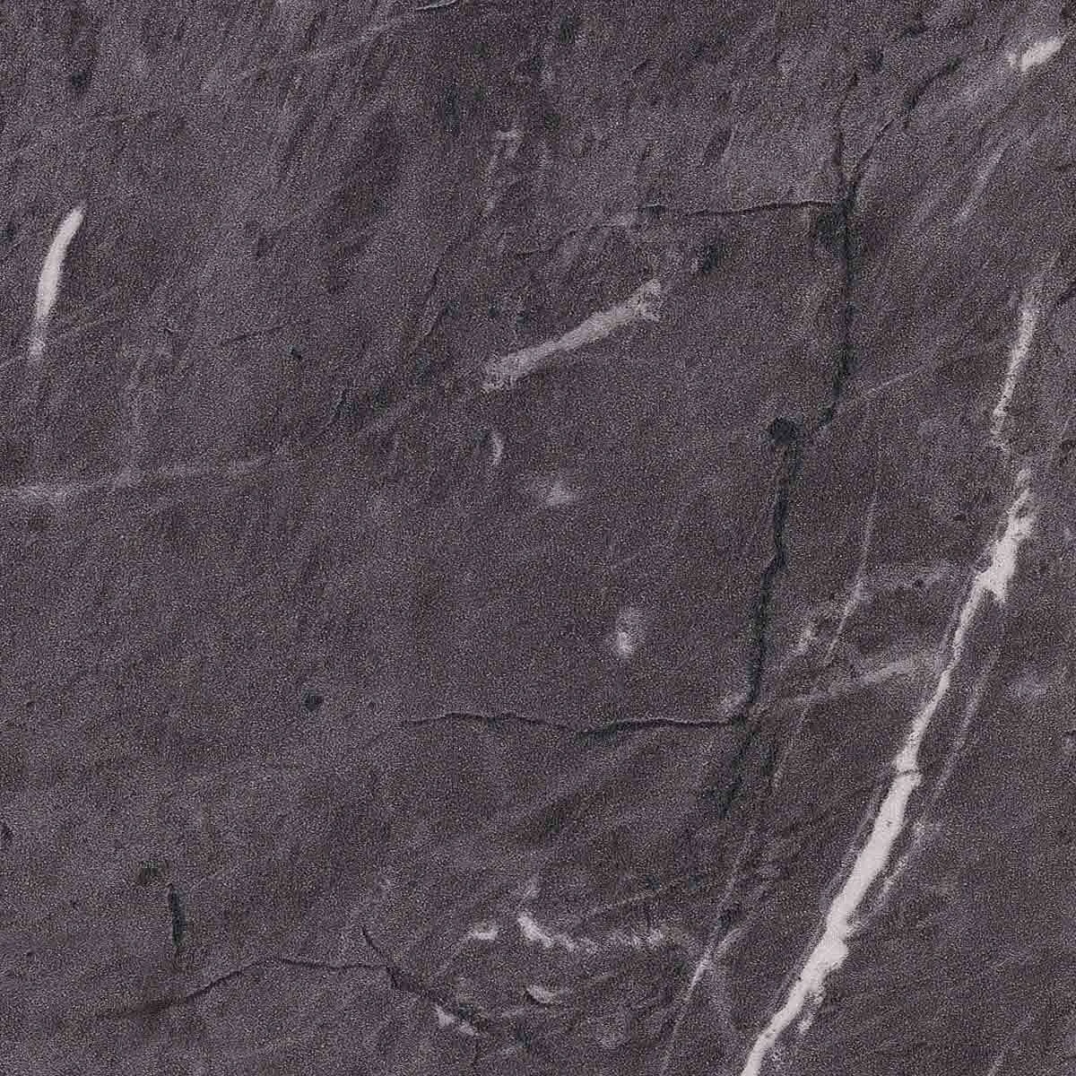 Close-up of cracked gray lamiante surface with white veins.