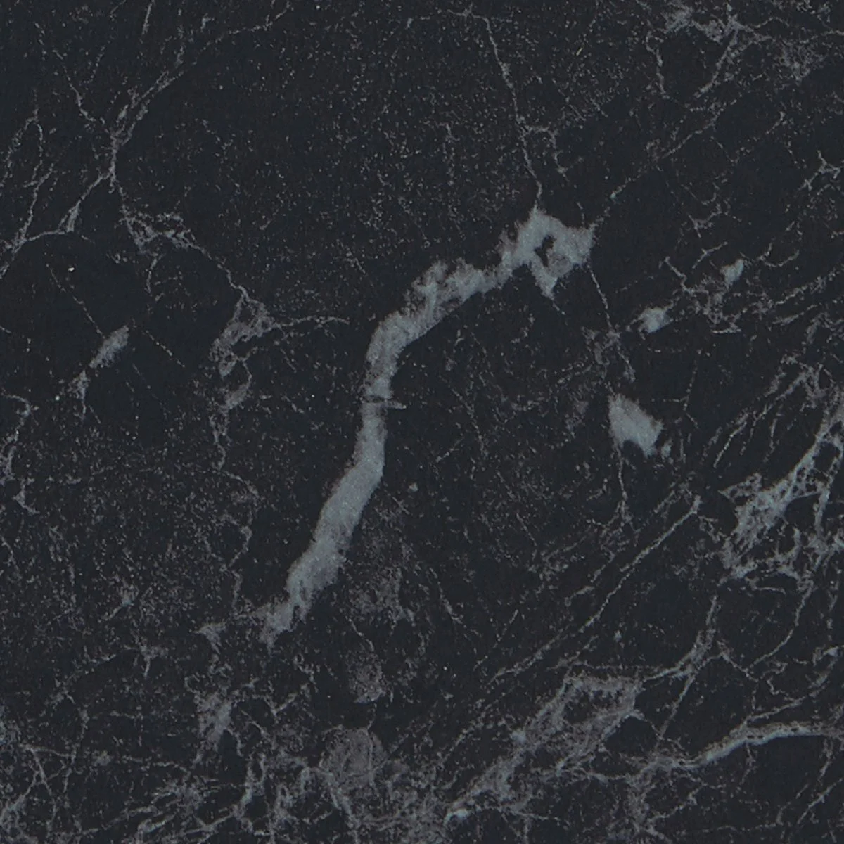 Close-up of a black laminate surface with white veining.