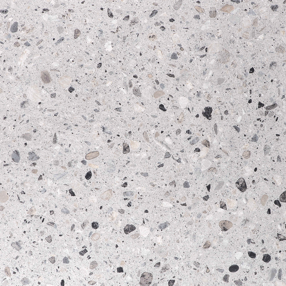 Close-up of a speckled concrete surface with various small stones and aggregates embedded.