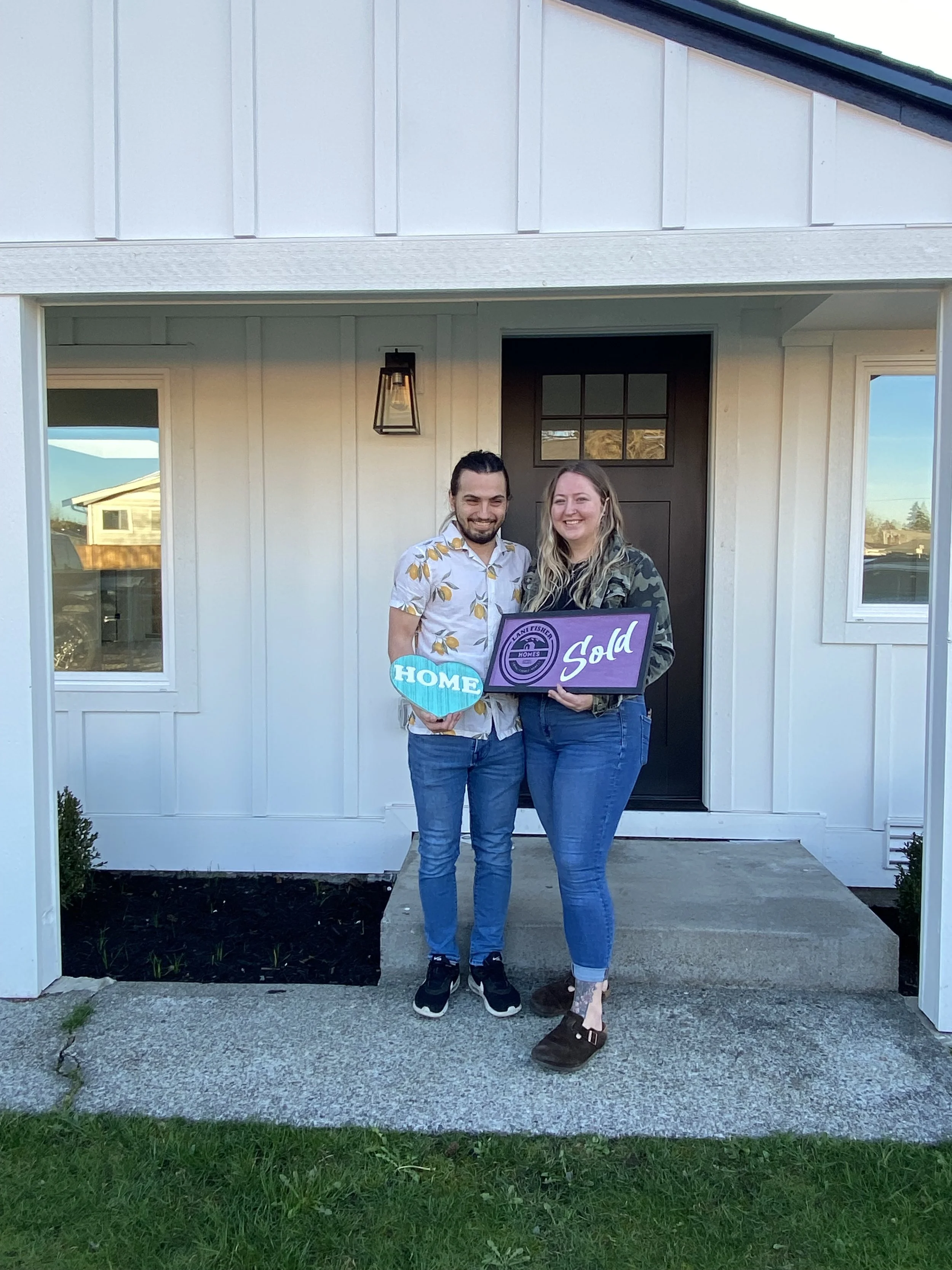 Pacific Northwest Realtor and Veteran Lani Fisher celebrates with a young couple in their 20s who just bought their first home — showcasing trust, excitement, and expert real estate guidance through Lani Fisher Homes across Washington.