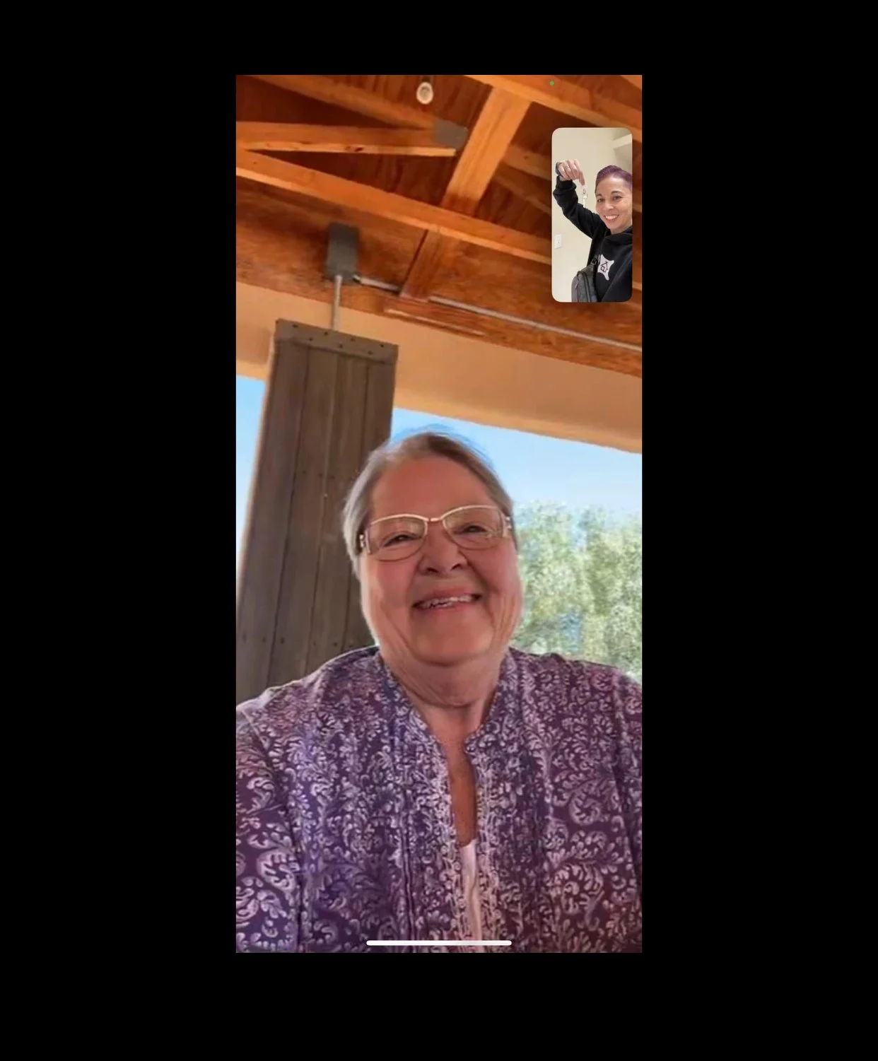 Senior client smiling on a video call with Pacific Northwest Realtor and U.S. Veteran Lani Fisher — celebrating receiving the keys to her new Washington home after a successful relocation from Arizona with Lani Fisher Homes.